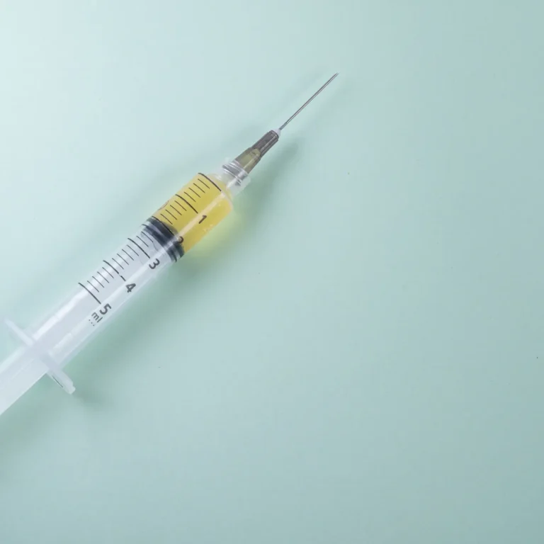plastic-syringe-green-background